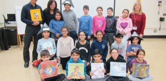 Students in Jessica Citrin and Shari Rich’s fourth-grade class are photographed with library media specialist Andrea Gerstenblatt and author and illustrator Chris Soentpiet. (Photo courtesy of the Great Neck Public Schools)