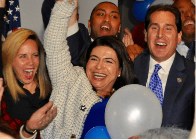 Anna Kaplan, flanked by Hempstead Supervisor Laura Gillen and state Sen. Todd Kaminsky, is declared the victor of the state Senate District 7 race at the Democrats' election party in Garden City. (Photo by Luke Torrance)