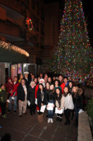 Students, dignitaries and other guests pose in front of the Inn at Great Neck's Christmas tree. (Photo by Russell Lippai)
