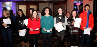 South High School's performers take a quick break for a photo at the Inn at Great Neck's annual tree lighting party. (Photo by Russell Lippai)