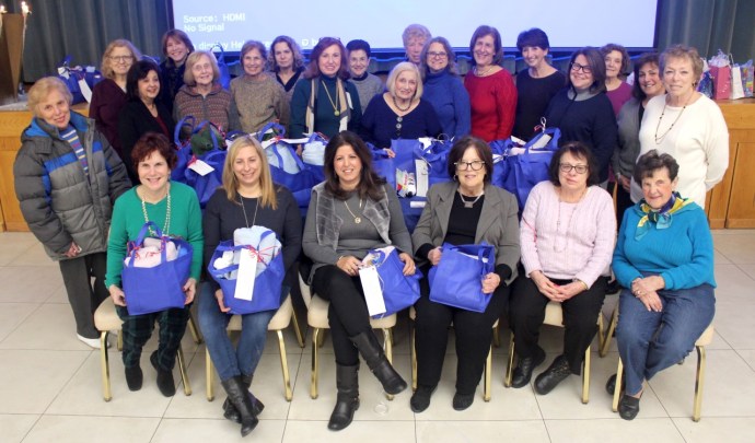 Temple Beth Sholom Sisterhood members donated and wrapped health and beauty products during its annual Chanukah party for the residents of Broken but Not Destroyed Women’s Shelter in Hempstead. The women, many of whom have been the victims of domestic violence, reside in the shelter with their children while recuperating and preparing themselves to reenter the workforce. (Photo courtesy of Temple Beth Shalom)