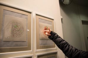 Shi Xiangdong points at a bowl of noodles, made by his wife, that he painted. (Photo by Demi Guo)