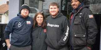 Donna Plakstis and her sons Tyler and Ryan, pictured here with employee William Robertson, will be running the family business Doray Enterprises in Great Neck for as long as it lasts. (Photo by Janelle Clausen)