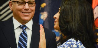 New York Gov. Andrew Cuomo swears in Anna Kaplan as state Senator as her husband Darren, a trustee in the Village of Kensington, looks on. (Photo by Janelle Clausen)