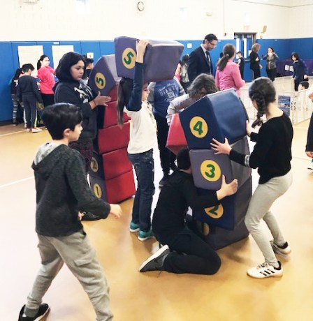 E.M. Baker students use engineering skills to build a parabolic arch out of large foam blocks, while learning about the function of a keystone and how force is dispersed. (Photo courtesy of the Great Neck Public Schools)