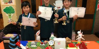 Great Neck South Middle School students Arthur Zhang, Richard Oh, and Ivan Xu are photographed with their certificates and trophies from the regional Future City Competition on Jan. 19. (Photo courtesy of the Great Neck Public Schools)