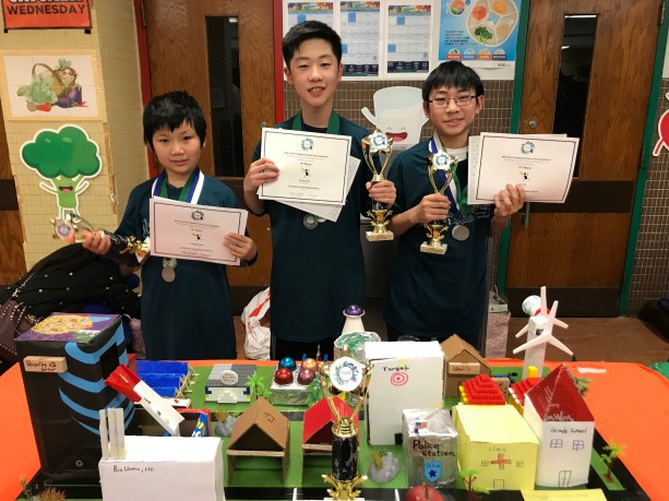 Great Neck South Middle School students Arthur Zhang, Richard Oh, and Ivan Xu are photographed with their certificates and trophies from the regional Future City Competition on Jan. 19. (Photo courtesy of the Great Neck Public Schools)