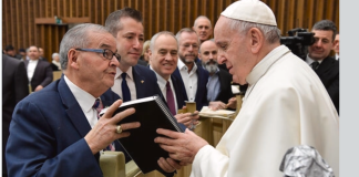 Assemblyman Anthony D'Urso, pictured here with Great Neck lawyer Michael Weinstock and State Comptroller Tom DiNapoli of Great Neck, hands a bound copy of a diary that corroborates how D'Urso's family protected a Jewish family during World War II to Pope Francis. (Photo courtesy of Michael Weinstock)