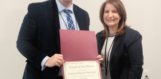 Library Director Denise Corcoran presents the Great Neck Library Staff Excellence Award certificate to recipient Christopher Van Wickler. (Photo courtesy of the Great Neck Library)