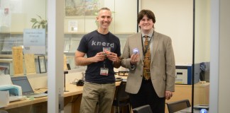 Adam Hinz and Christopher Van Wickler show off some of the objects created in the library's new STEM lab. (Photo by Janelle Clausen)