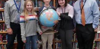 Michael Zanetti, center, is pictured with runners-up Sasha Stern and Isabella Pavolvici, along with Herricks Middle School Principal Brian McConaghy and Social Studies Chairperson Tony Cillis. (Photo courtesy of Herricks Public Schools)