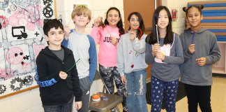 During a presentation by the DEC about the water cycle and the importance of water conservation, Saddle Rock fifth graders participate in an activity where they collect beads from different stations, demonstrating the journey of a water molecule from glaciers and bodies of water into clouds, rain, and groundwater, plants, and humans. (Photo courtesy of the Great Neck Public Schools)