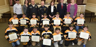 Superintendent Jason R. Marra, Commissioners Tina Stellato, Robert Lincoln, Jr., Frank Cilluffo, Council Member Lee Seeman, Town Clerk Wayne Wink and Council Member Veronica Lurvey are pictured with the victorious Great Neck Bruins. (Photo courtesy of the Town of North Hempstead)