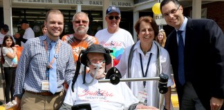 Ride for Life honoree Christopher Lynch (left) is photographed with Ride for Life founder Christopher Pendergast (center), Ride participants Paul Weisman and Nelson Colon, retired Baker Principal Sharon Fougner, and current Baker Principal Dr. Michael Grimaldi during the Ride for Life visit to E.M. Baker School in May 2018. (Photo courtesy of Great Neck Public Schools)