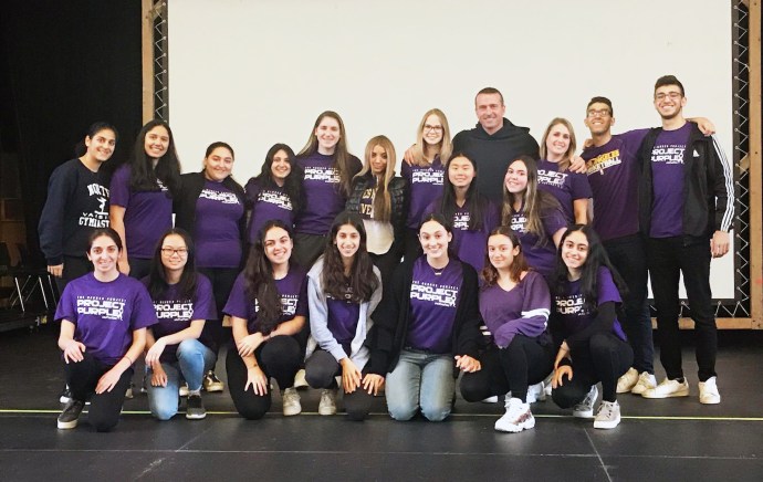 North High School recently hosted their annual Project Purple Week, sponsored by the school’s Students Against Destructive Decisions (SADD) Club. The national Project Purple initiative aims to provide students and athletes with motivation and support to make healthy choices and deter them from turning to drugs and alcohol to cope with life’s challenges. This year’s program at North High included a visit from Project Purple founder Chris Herren, who led an assembly for ninth and tenth-grade students. His visit was made possible with support from school administrators and the North High PTO. Mr. Herren is a former NBA athlete who travels across the country to share his personal experiences with substance abuse and addiction. Mr. Herren first visited North High in November 2013 to address the entire student body, and that visit inspired the SADD Club to initiate Project Purple within the school. North High’s annual Project Purple Week activities include sharing information about substance abuse and addiction, as well as a series of morning announcements about drug trends in adolescents. Ninth-grade health classes also view Mr. Herren’s documentary in class. The North High SADD Club advisor is health teacher Lauren Mock. (Photo courtesy of the Great Neck Public Schools)