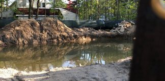 A property in the Village of Great Neck has filled with water over a course of months, in effect creating a pool where a home would otherwise be. (Photo provided to the Great Neck News)