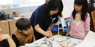 Angela Pian teaches Chinese Calligraphy to Ms. Seiden’s third-grade class as part of the Lakeville School’s annual Teach-In event. (Photo courtesy of Great Neck Public Schools)