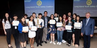 Robert Zahn and award-winning students from GNPS/TV are congratulated by musician Meredith O’Connor and Rene Fiechter, an assistant district attorney and the director of community affairs at an awards ceremony on June 4. (Photo by Anna Zahn)