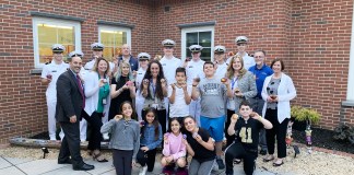 John F. Kennedy School Principal Ronald Gimondo, Assistant Principal and student council co-advisor Michelle Bell, art teacher Christine Mulligan, fifth-grade teacher and student council co-advisor Rebecca Schapira, Superintendent Teresa Prendergast, JFK head custodian Glen Ryder, and Assistant Superintendent Kelly Newman are joined by student council representatives and cadets from the Merchant Marine Academy for the grand opening of a colorful new rock garden. (Photo courtesy of Great Neck Public Schools)