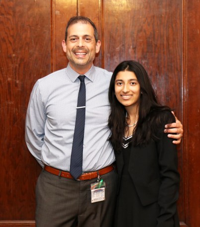 North High School junior Preethi Kumar is congratulated by Principal Daniel Holtzman for being recognized by the Anti-Defamation League. (Photo courtesy of Great Neck Public Schools)