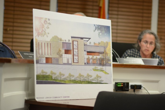 A rendering of the proposed recreational center for the United Mashadi Jewish Community of America sits in front of the Village of Great Neck Board of Trustees. (Photo by Janelle Clausen)