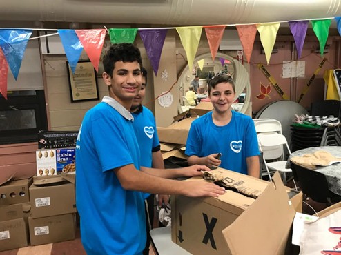 Silverstein Hebrew Academy students package food for over 250 families