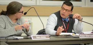 North Shore Superintendent of Schools Peter Giarrizzo speaks with Sara Jones, the school board president, during a business meeting about the impact of a possible settlement between LIPA and Nassau County. (Photo by Janelle Clausen)