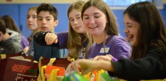 Great Neck teens lined up to assemble packages for low-income families on Monday, as part of a day of service on Martin Luther King day. (Photo by Janelle Clausen)