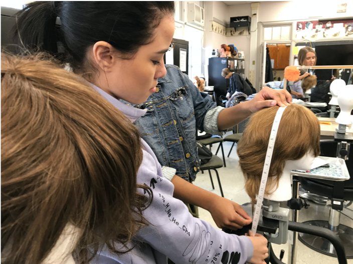 Cosmetology students work with Hair We Share