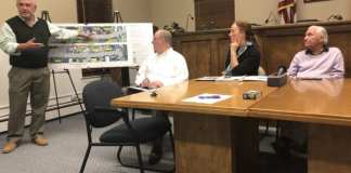 Project lead Gil Anderson, left, presents the plans for Manorhaven Boulevard, as Nassau County Public Works Commissioner Ken Arnold, Nassau County Legislator Delia DeRiggi-Whitton and Manorhaven Mayor Jim Avena look on at a 2019 meeting regarding the plans. (Photo by Rose Weldon)