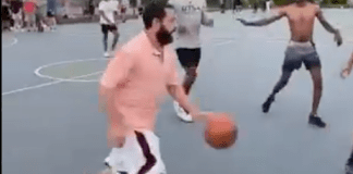 Comedian Adam Sandler, in orange, dribbles during a pickup basketball game with locals at Christopher Morley Park in Roslyn. (Screencap via Instagram, @RoboBball3)