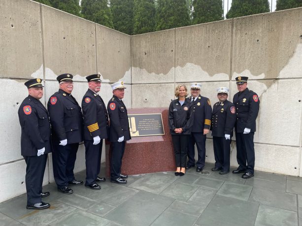 Nassau County Executive Laura Curran and fire officials pose alongside the newly unveiled First Responders Memorial. (Photo by Brandon Duffy)