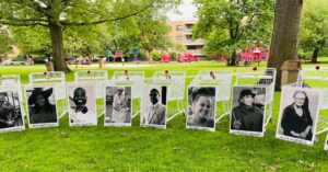 A tribute to the victims of the Buffalo shooting, with posters of all the victims and their names propped against shopping carts.