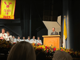 Chaminade High School's president Brother Thomas Cleary is pictured standing at the podium announcing Chaminade's Man of the Year award.