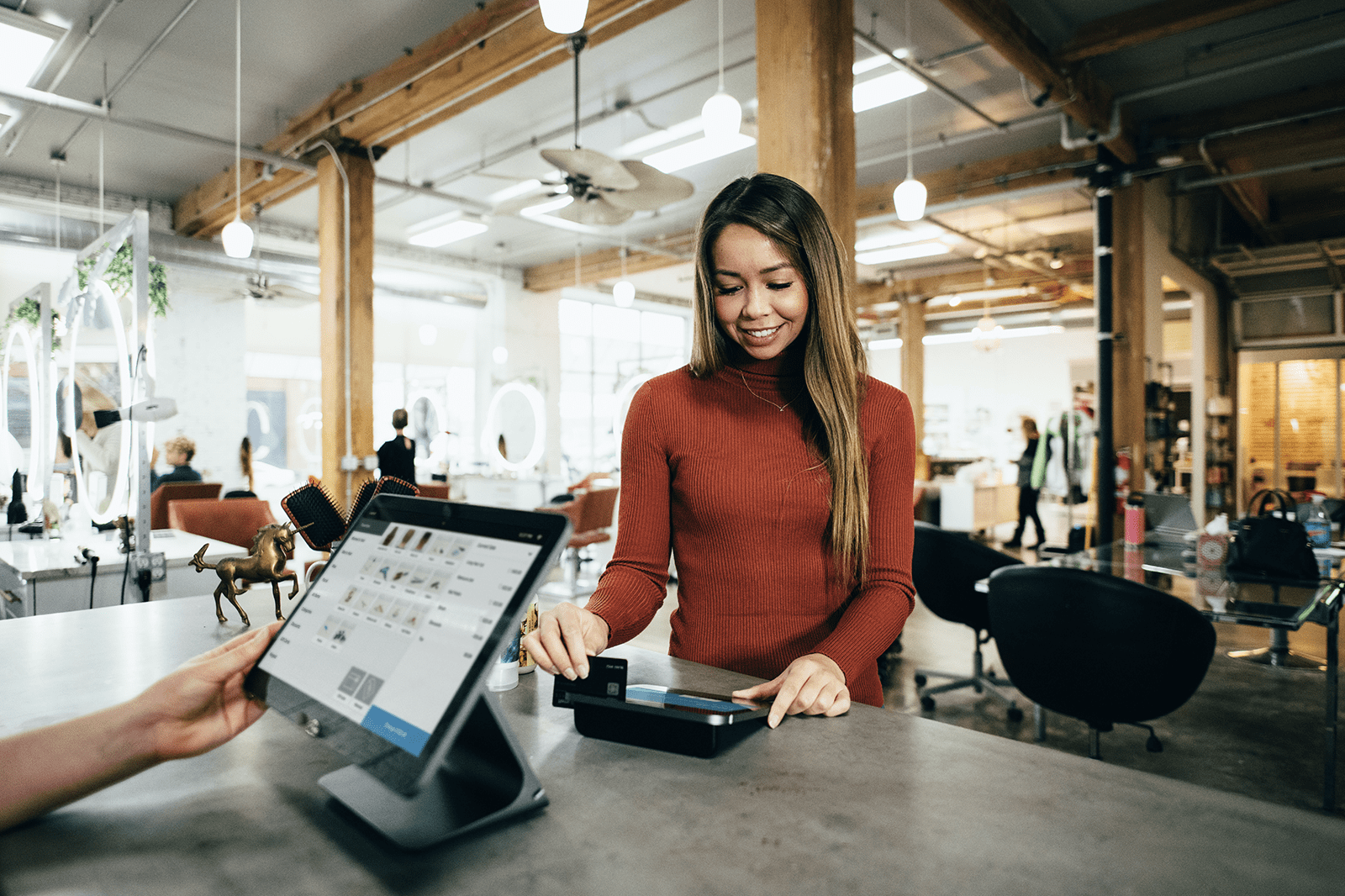 A woman using a giftcard at a retail store