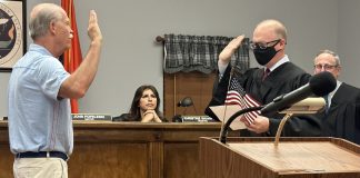 Manorhaven Village Justice swears in new Trustee Jeffrey Stone at the village's annual reorganizational meeting Wednesday night.