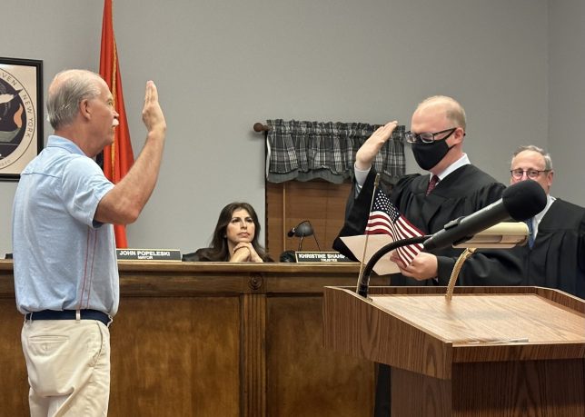 Manorhaven Village Justice swears in new Trustee Jeffrey Stone at the village's annual reorganizational meeting Wednesday night.