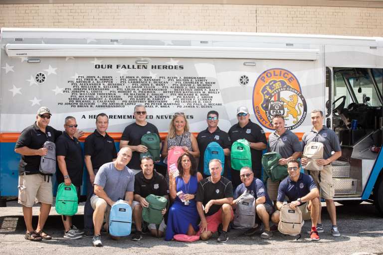 Legislator DeRiggi-Whitton, Nassau County PBA host back-to-school backpack giveaway at Glen Cove H.S.