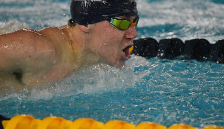 Port Washington swimming’s Apat needs his lungs for the pool, and on deck