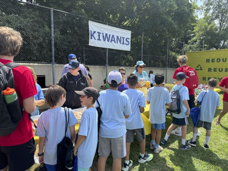 Kiwanis Club of County Seat, Mineola cooks and serves over 400 hot dogs to the campers at the summer rec program